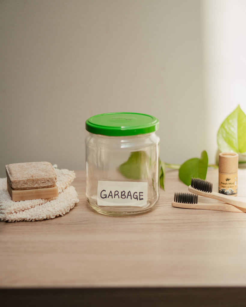 Jar With Garbage Inside Next To Zero Waste Products Swaps For Home