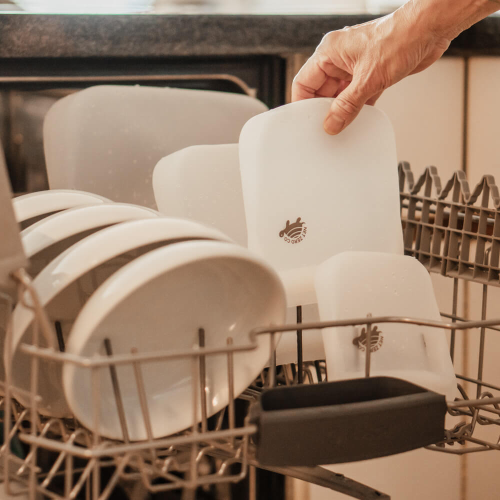 Hand pulling small Silicone Zip Sealer out of dishwasher.