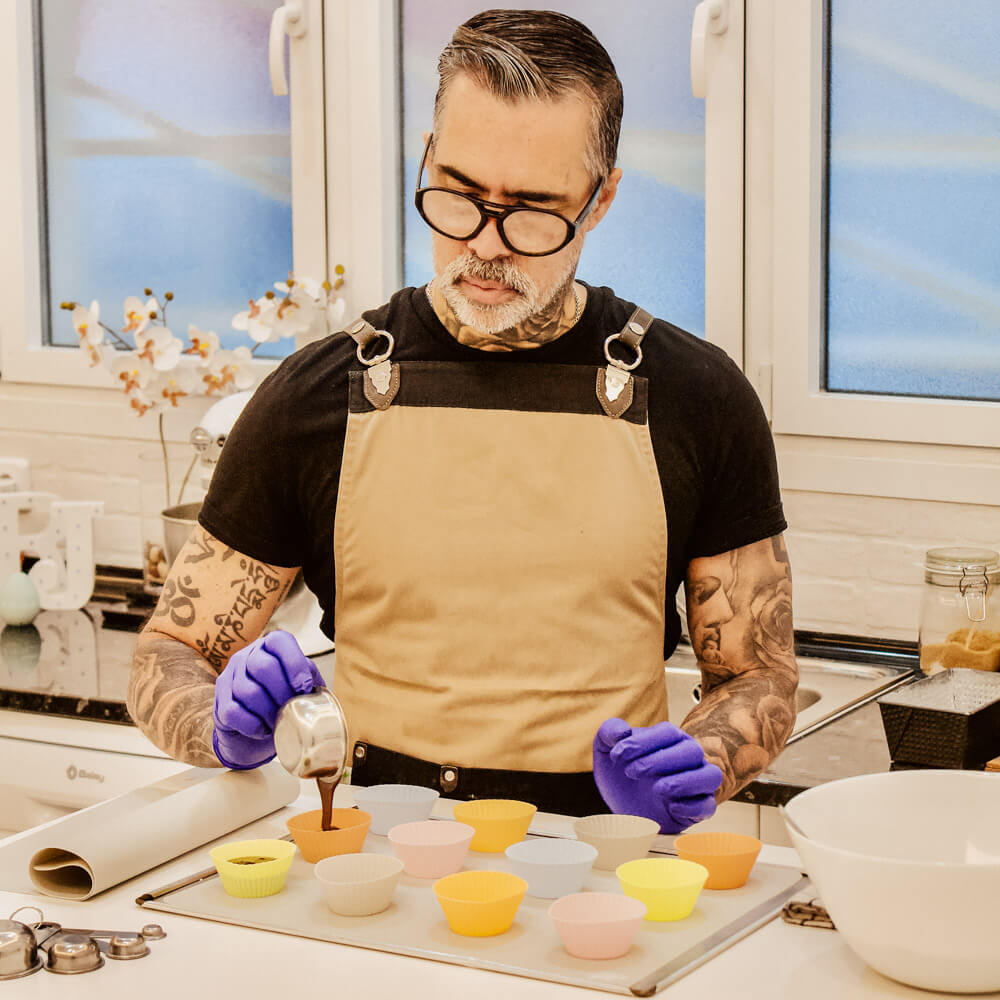 Man making muffins with silicone baking cups.