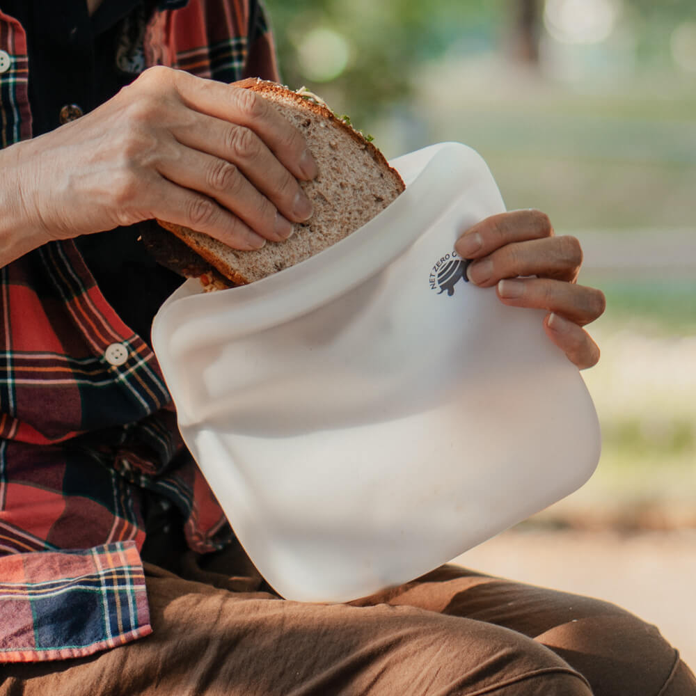 Hand taking sandwich out of silicone zip sealer by Net Zero Co.