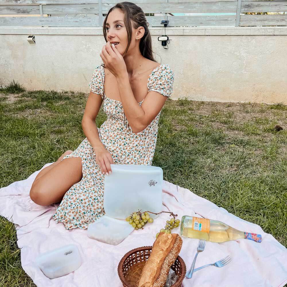 Woman using silicone zip sealers for picnic.